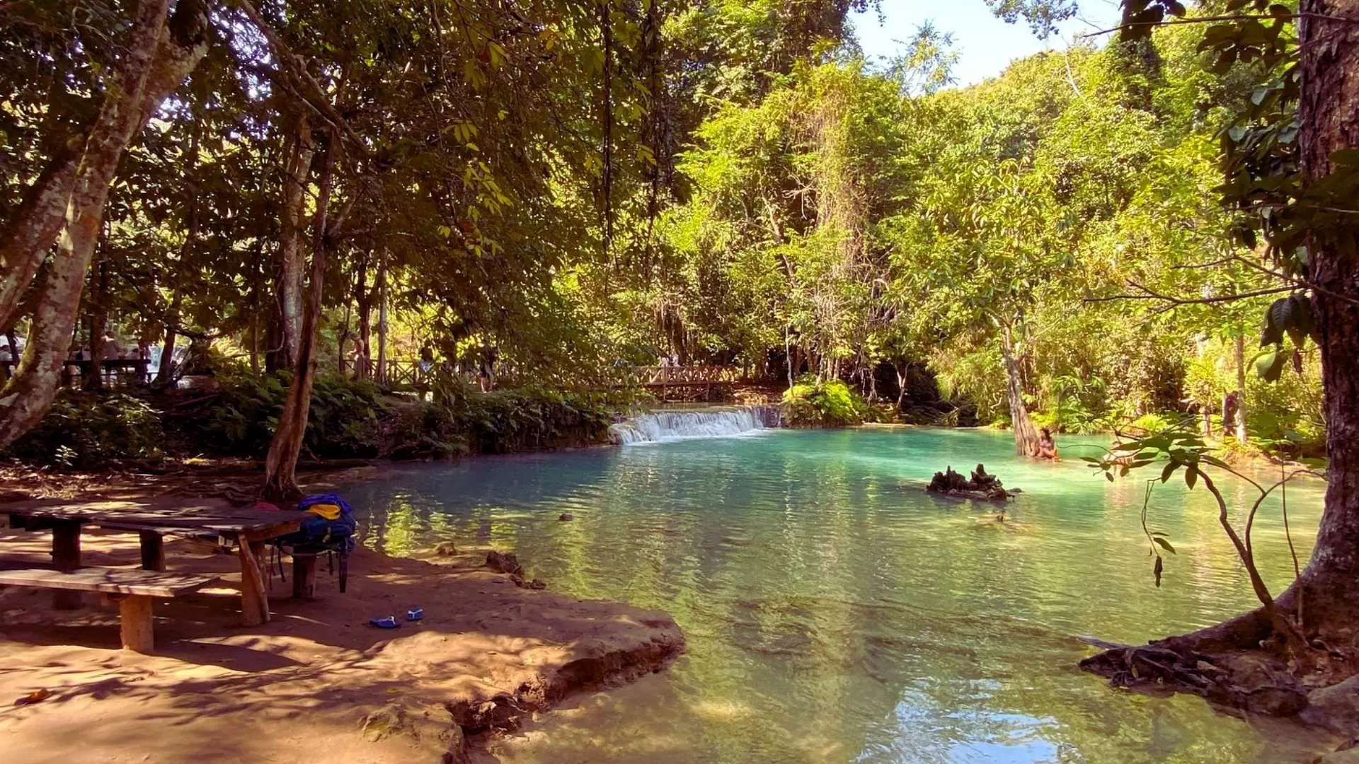 You can picnic with your loved one by Kuang Si’s green waters