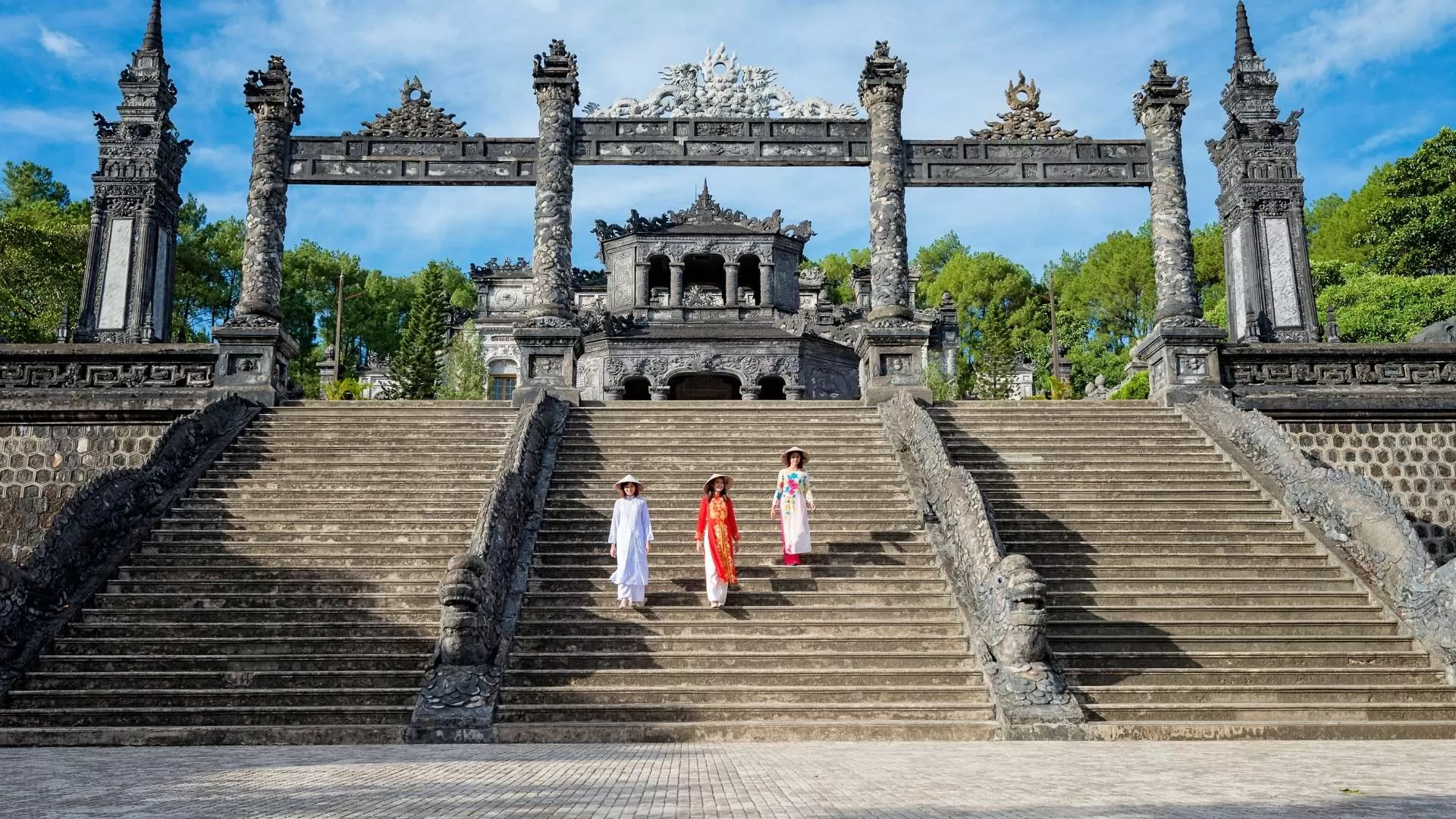Wearing ao dai when visiting tombs for an authentic Vietnamese experience